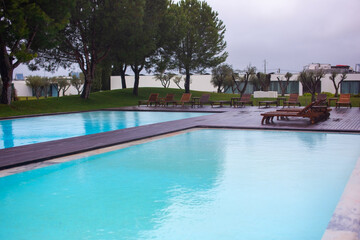 Swimming pool with sunbeds and umbrellas in a luxury resort