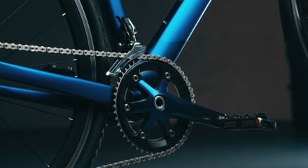 Close-up of a blue bicycle crankset and chain, highlighting precision engineering