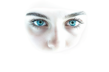 A woman's face with blue eyes and a white background