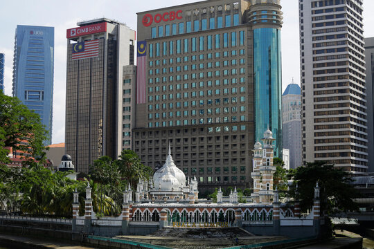 Kuala Lumpur, Malaysia - August 20, 2023: Masjid Jamek Sultan Abdul Samad mosque is seen, backgrounded by high rise buildings of OCBC, CIMB Bank and UOB banks.
