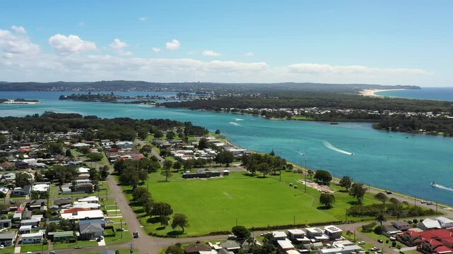 Wide aerial landscape panorama of Swansea town Lake Macquarie to Pacific ocean 4k.
