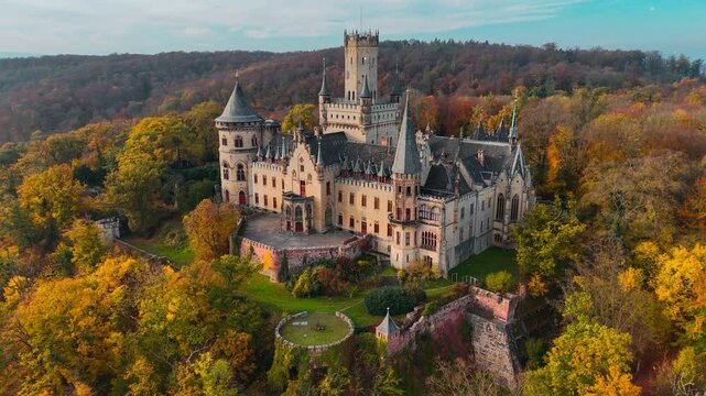 Aerial drone view of medieval castle Marienburg in forest on hill near Hanover in Lower Saxony, Germany. High quality 4k footage