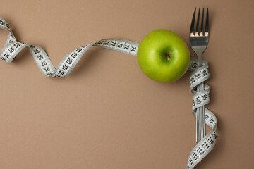 An Artistic Arrangement of a Fork and a Measuring Tape Set Against a Vibrant Background