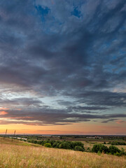 Beautiful sunset over a field with trees in the background