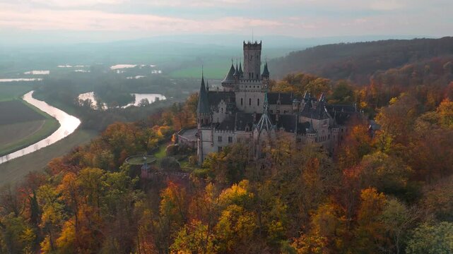 Aerial drone view of medieval castle Marienburg in forest on hill near Hanover in Lower Saxony, Germany. High quality 4k footage