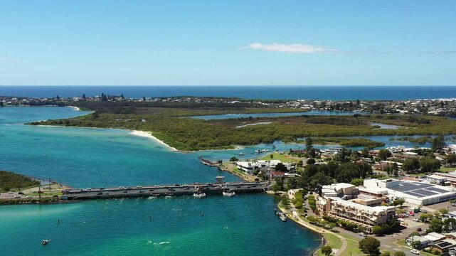Aerial panning around Swansea bridge from Lake Macquarie to Pacific ocean Australia.
