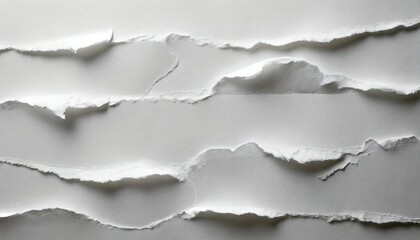 Fototapeta premium Torn white paper creates texture and depth on a plain background