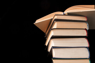Stack of old books on black background