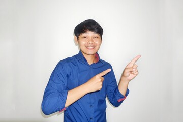 Asian Indonesian man wearing a plain blue shirt on a white background with happy expressions in various styles by expressing his hands