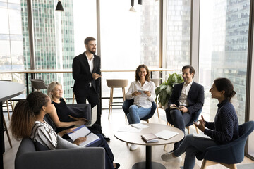 Group of diverse professionals engaged in lively conversation during meeting in modern office, leading friendly collaborative discussion, sharing creative ideas and solutions. Communication, teamwork