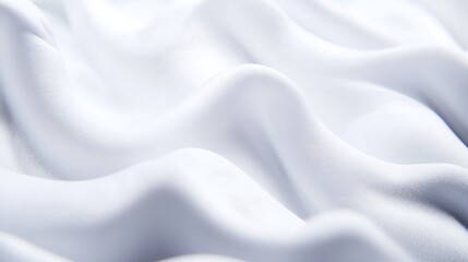 Fototapeta premium Close-up of smooth, white fabric draped elegantly, showcasing soft textures and gentle folds
