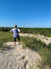 women looking out on sand dune North Carolina outer banks