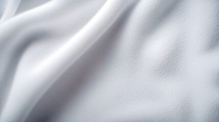 Fototapeta premium Close-up view of soft, white fabric showcasing elegant folds and texture for textile design