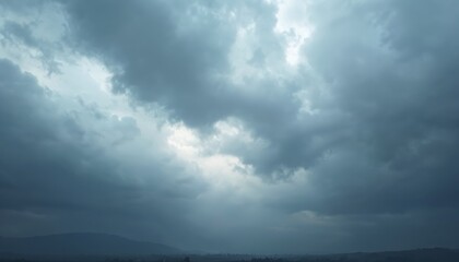 Fototapeta premium Dramatic overcast sky with dark clouds suggests impending storm. Gloomy mood settles over landscape. Threatening weather looms over terrain. Dark clouds fill sky. Vast horizon hints at land. Heavy