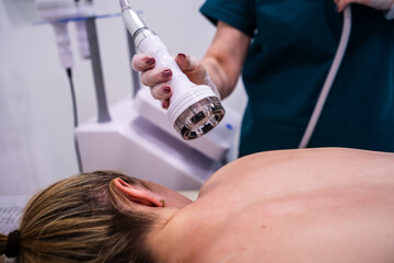 RF massage. Hardware cosmetology. Young woman getting rf lifting procedure in a beauty parlour.