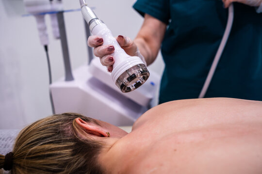 RF massage. Hardware cosmetology. Young woman getting rf lifting procedure in a beauty parlour.