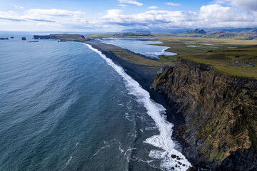 Aerial view of waves breaking on the shoreline black beach Reynisfjara in Iceland in VIK Myrdal in Golden Circle Area showcasing dynamic and natural patterns, encapsulating the essence of the Atlantic