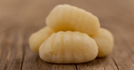 Close-up of fresh gnocchi on rustic wooden table, showcasing texture and detail