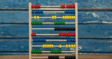 Wooden abacus on rustic table for learning and education in school setting © vectorfusionart