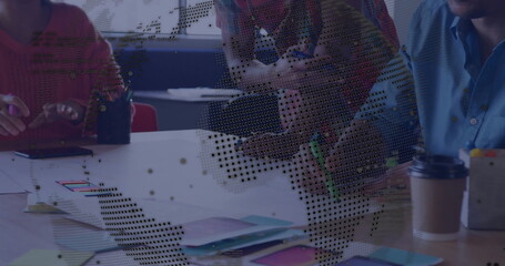 Collaborating on project, team brainstorming ideas with digital overlay at office desk