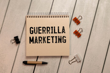 Text sign showing guerilla marketing. The text is written on a small wooden blackboard.