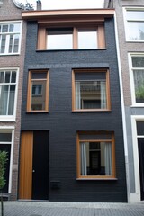 Experience the beauty of modern minimalist architecture, showcasing a striking black facade complemented by warm wooden accents all set within a vibrant urban environment