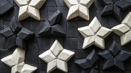Abstract geometric patterns with black and white star-shaped tiles on a textured surface