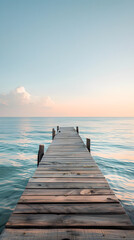 Naklejka premium Idyllic Wooden Pier Extending Into Calm Sea Under Golden Sunset With Clear Sky and Gentle Waves