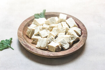 pieces of white tofu in a wooden plate	