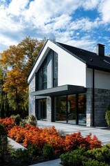 Modern architectural style home surrounded by vibrant autumn foliage in a serene suburban setting showcases the beauty of nature during fall