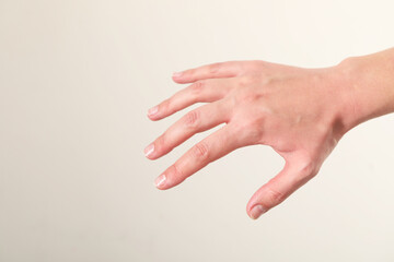 Woman with visible hand veins on white background, closeup