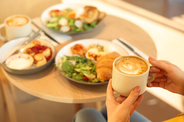 Woman having tasty breakfast in cafe, closeup