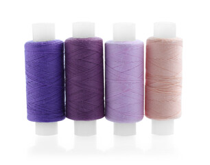 Spools of bright sewing threads isolated on white