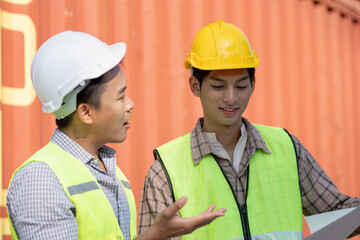 Logistics collaboration between engineers in shipping yard container terminal professional exchange industrial environment close-up perspective