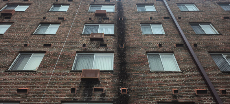 looking up into the sky at a brick building