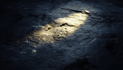 Dark stone surface, light beam, textured floor, interior scene