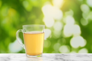Green tea in cup on marble table outdoors. Space for text
