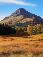 Obraz premium Stunning autumn landscape with a majestic mountain backdrop and vibrant golden grass fields : Generative AI