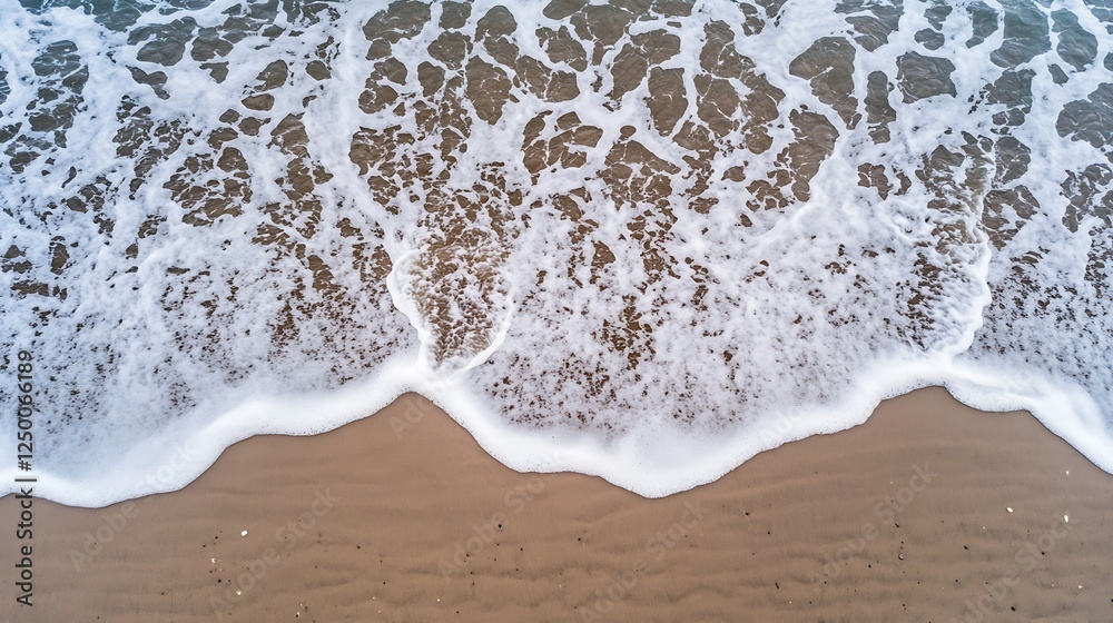 Poster top down view of ocean waves crashing on sandy beach with vivid blue water texture : generative ai