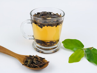 Brewing aromatic tea. Cup with raw tea - on white background