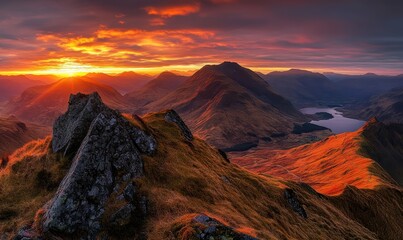 Fiery sunset over majestic mountain range and serene lake.