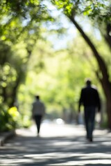Fototapeta premium Blurry Silhouette of Two People Walking on a Tree Lined Road in Bright Daylight : Generative AI