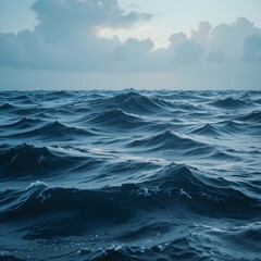 Gentle yet powerful ocean waves ripple under a cloudy sky, evoking a sense of vastness and tranquility.