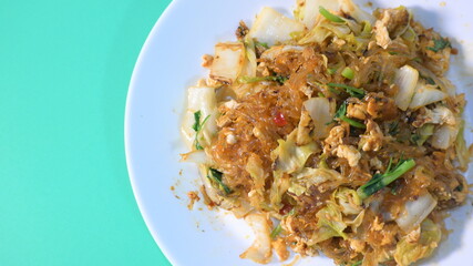 stir fried sukiyaki with egg and pork on white plate