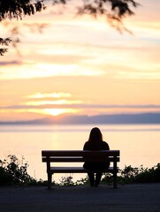 Obraz premium Contemplative person sitting on a park bench gazing at the sunset over tranquil waters : Generative AI
