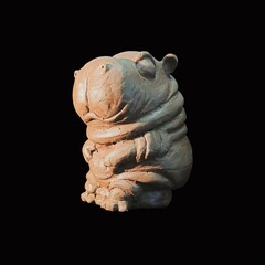 figurine of  hippopotamus. clay statue Picture of a hippopotamus on a black background. Isolated