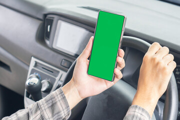 Men holding smartphone mockup green screen while driving on car