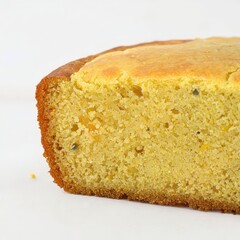 the AI Image Generator, Golden Cornbread Loaf with Visible Sweet Corn Kernels Inside