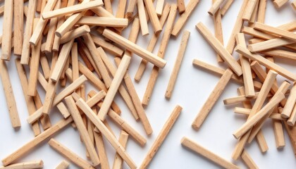 Random Arrangement of Small Wooden Sticks on White Surface