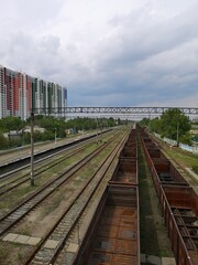 Fototapeta premium A railway siding in Kyiv Ukraine. Apartment buildings stand in the distance.